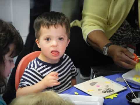 a child sitting at a table