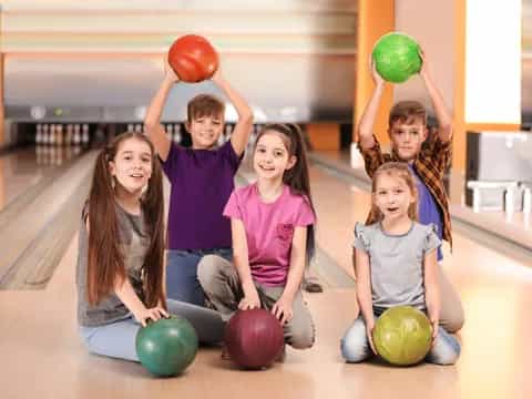 a group of kids holding balls
