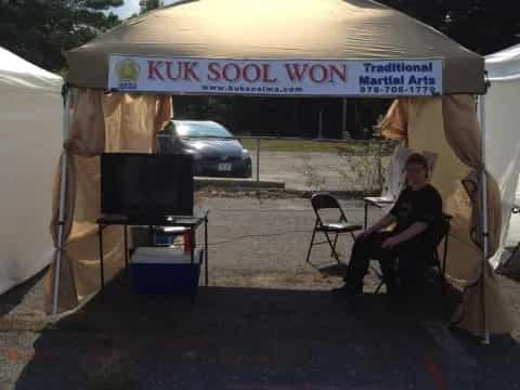 a person sitting under a tent