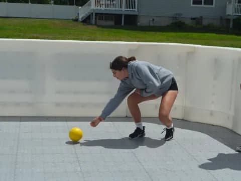 a man playing with a yellow ball