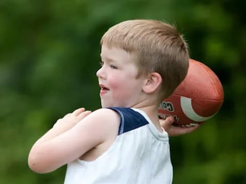 a boy throwing a ball