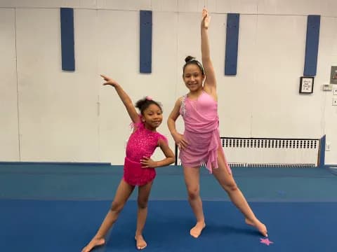 two girls in dresses dancing