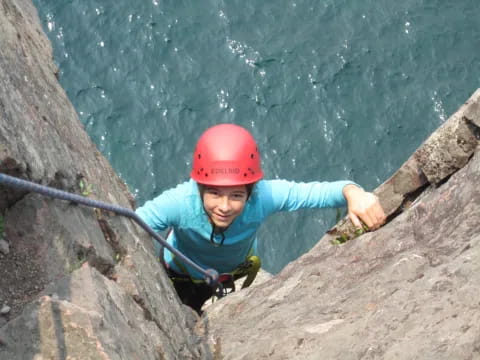 a young boy climbing a rock wall