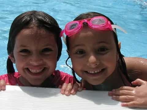 a couple of girls in a pool