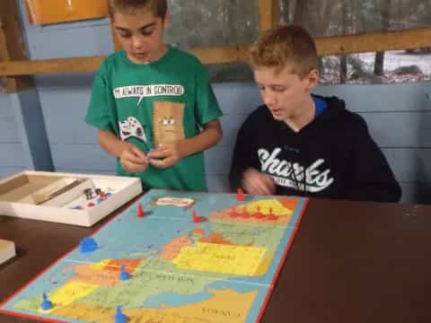 a couple of boys playing a board game