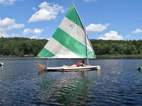 a person in a sailboat on water