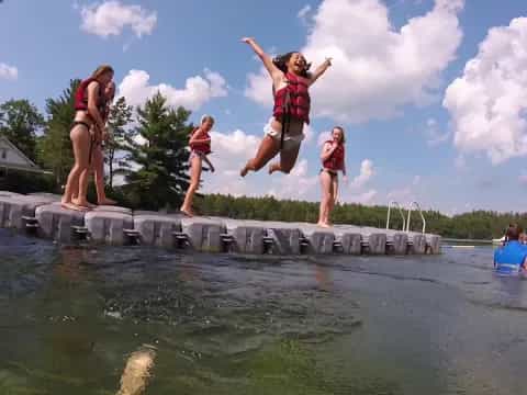 a group of people jumping into water