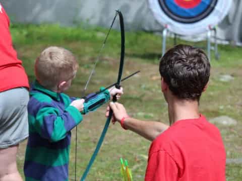 a couple of boys shooting bows