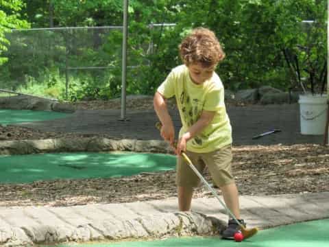 a boy playing with a shovel