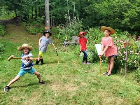 a group of kids playing with sticks
