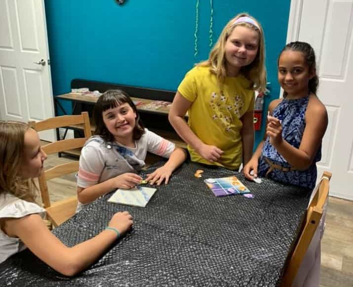a group of girls sitting at a table