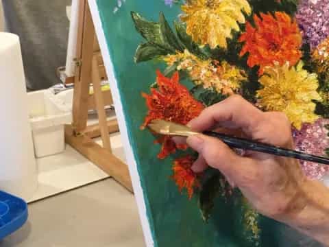 a person painting flowers