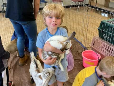 a child holding a goat