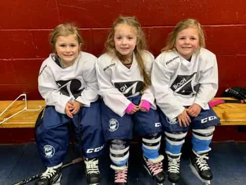a group of girls wearing hockey uniforms