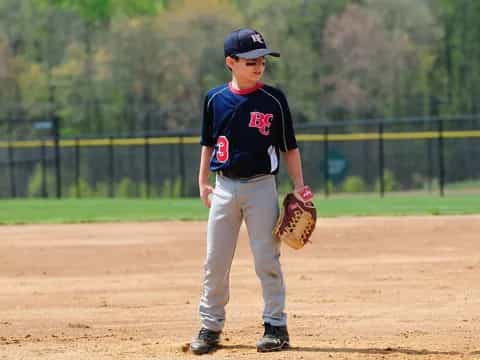 a boy in a baseball uniform