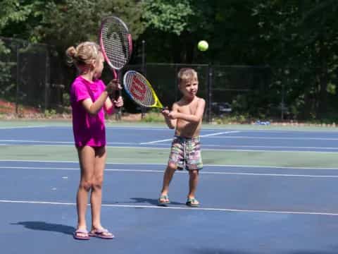 kids playing tennis on court