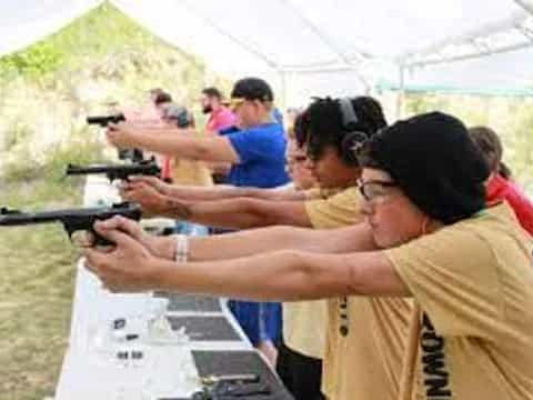 a group of people shooting guns