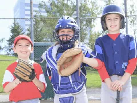 a group of kids wearing baseball uniforms