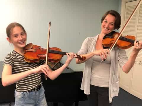 a couple of women playing violin