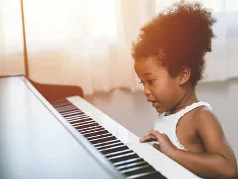a baby playing piano