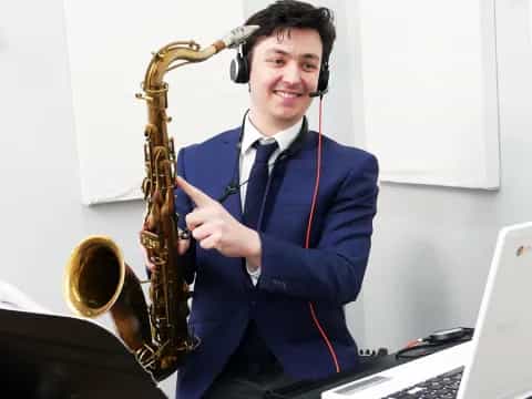 a man wearing headphones and playing a saxophone