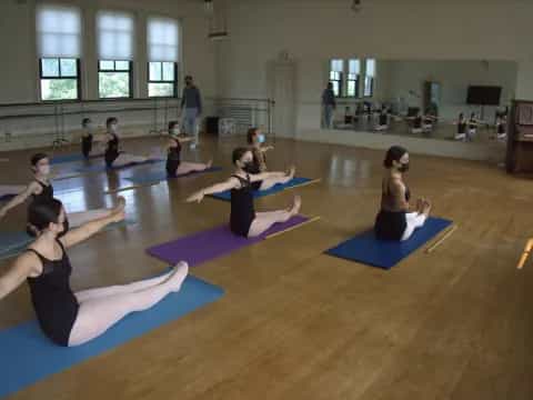 a group of people exercising in a room