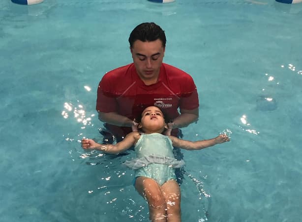 a man and a child in a pool