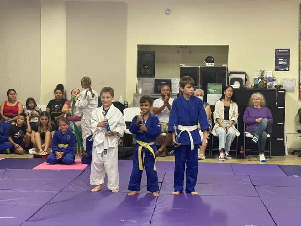 a group of children in karate uniforms