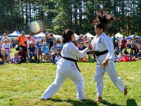 two people in white karate uniforms