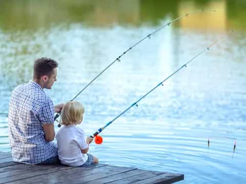 a man and a child fishing