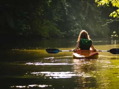 a person in a kayak in a lake