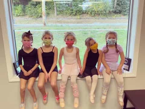 a group of girls wearing masks