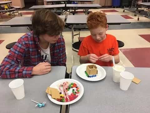 a couple of boys eating cake