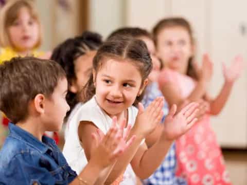 a group of children clapping