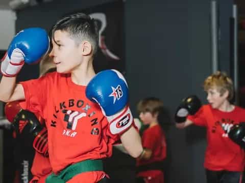 a group of kids wearing boxing gloves