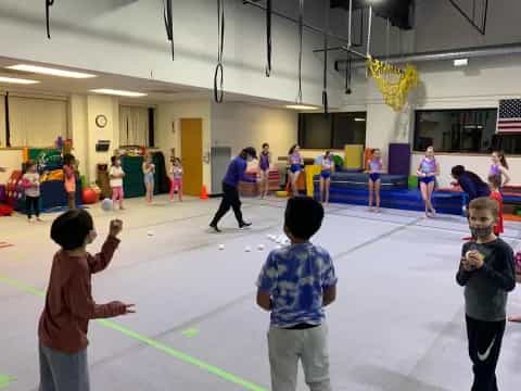 a group of children playing in a gymnasium