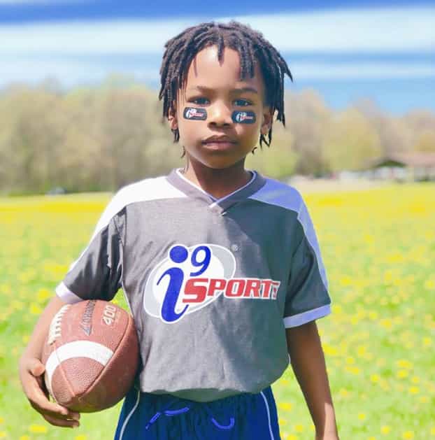 a young girl holding a basketball