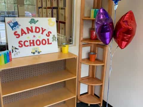 a room with a shelf and balloons