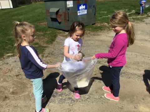 a group of girls holding a plastic bag