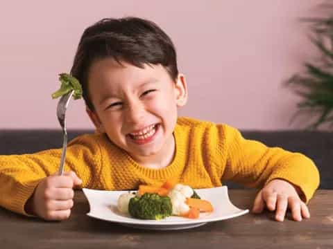 a boy eating a plate of food