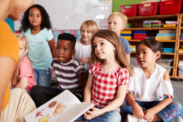 a group of children sitting in a classroom