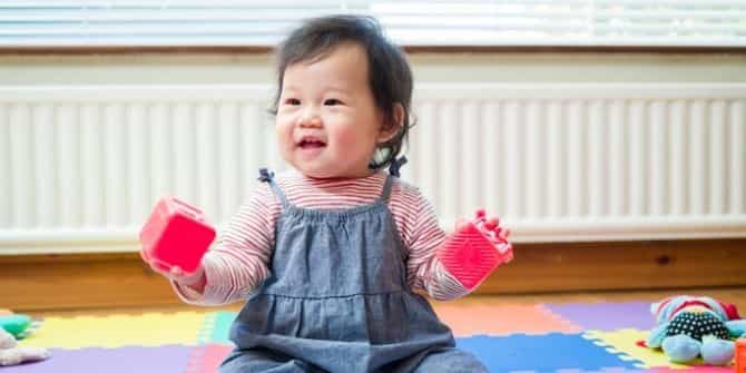 a baby sitting on a rug