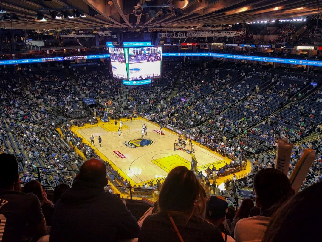 a basketball game is being played in a large arena