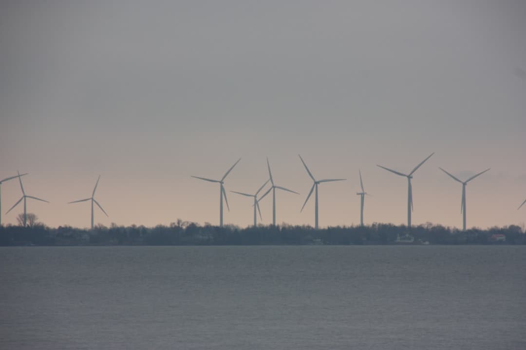 a row of wind turbines in the distance