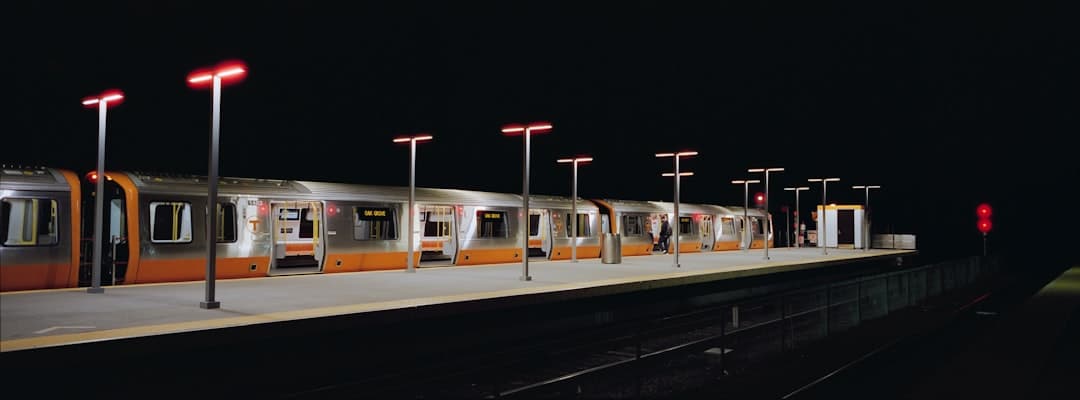 a train is stopped at a train station at night
